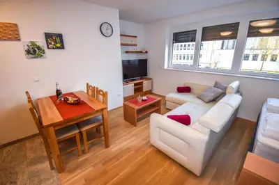 a living room with a white couch and a table at City Centre Lux in Maribor