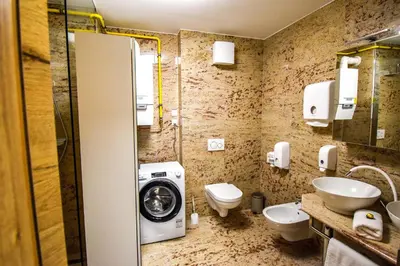a bathroom with a washing machine and a washer at City Centre Lux in Maribor