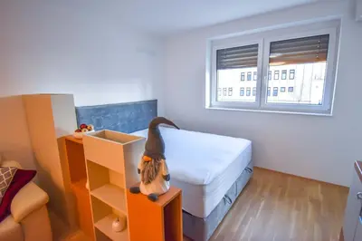 a small bedroom with a bed and a window at City Centre Lux in Maribor
