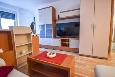 a living room with a large tv and a table at City Centre Lux in Maribor