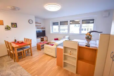 a living room with a kitchen and a dining room at City Centre Lux in Maribor