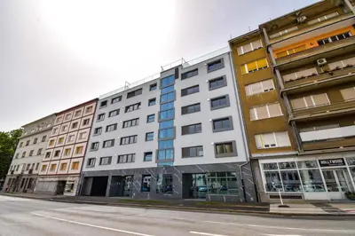 a row of buildings on a city street at City Centre Lux in Maribor