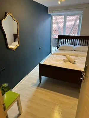 a bedroom with a bed with a mirror on the wall at Hostel Sleeping Beauty in Ljubljana