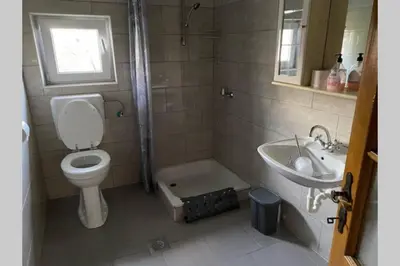 a bathroom with a toilet and a sink at Oaza miru v sožitju z naravo in Sveti Jurij ob Ščavnici
