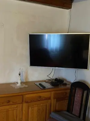 a flat screen tv hanging on a wall at Oaza miru v sožitju z naravo in Sveti Jurij ob Ščavnici