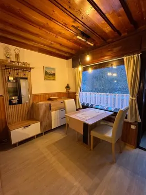 a dining room with a table and a window at Apartmaji pr' Matičo in Kranjska Gora