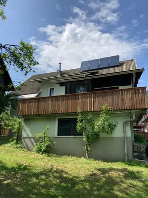 a house with solar panels on top of it at Apartmaji pr' Matičo in Kranjska Gora