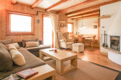 a living room with a couch and a table at Villa Pokljuka in Zgornje Gorje