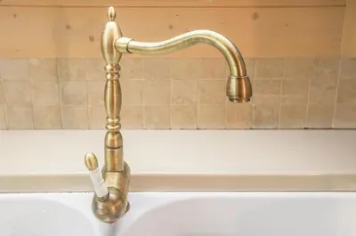 a gold faucet over a white bath tub at Villa Pokljuka in Zgornje Gorje