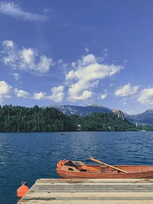a boat sitting at a dock on a lake at Villa Pokljuka in Zgornje Gorje
