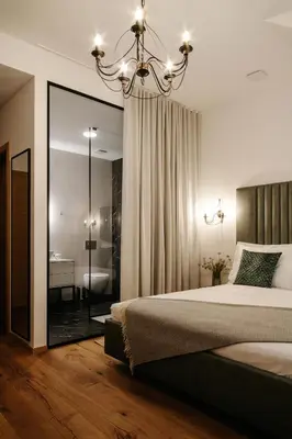 a bedroom with a large bed and a bathroom at Pr Kopač in Brezovica