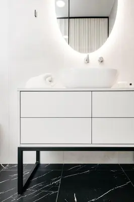 a white bathroom with a sink and a mirror at Pr Kopač in Brezovica