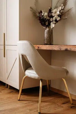a chair in front of a desk with a vase of flowers at Pr Kopač in Brezovica
