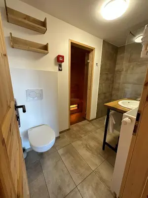 a bathroom with a toilet and a sink at Ribno Luxury Glamping in Bled
