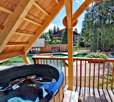 a backyard with a swimming pool and a wooden deck at Ribno Luxury Glamping in Bled