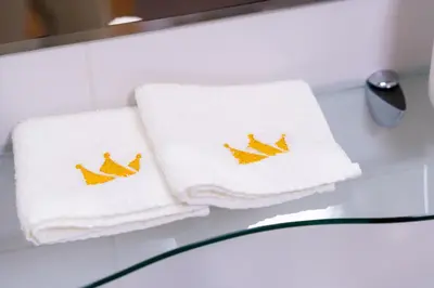 two towels with birds on them sitting on a table at Bella Mura Blue Apartment in Moravske Toplice
