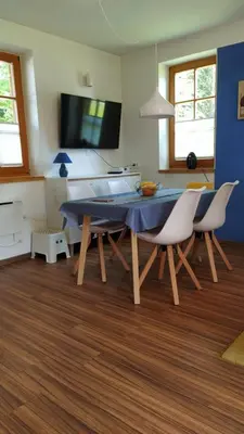 a dining room with a blue table and chairs at Tulpika1 in Moravske Toplice