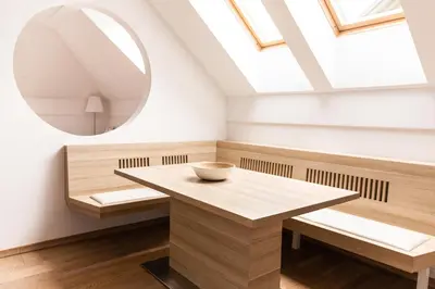 a dining room with a table and a mirror at Vigorous Bled Apartment in Bled