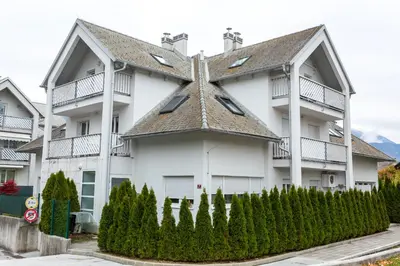 a large white house with a roof at Vigorous Bled Apartment in Bled