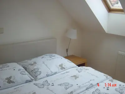 a bedroom with a bed with two pillows on it at Apartments Vrdjan in Cerknica