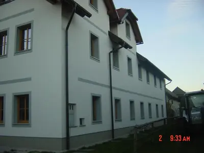 a white building with a lot of windows on it at Apartments Vrdjan in Cerknica