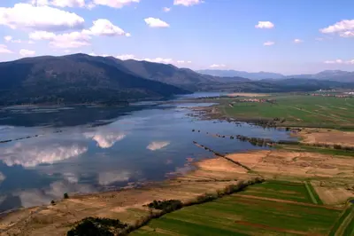 an aerial view of a river with mountains at Apartments Vrdjan in Cerknica
