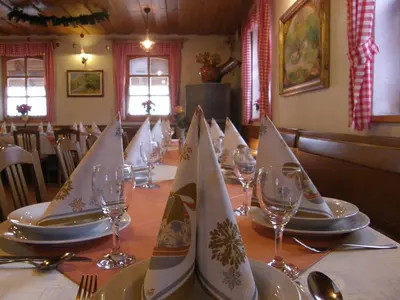 a table set with plates and wine glasses and napkins at Guesthouse Močivnik in Okroglice