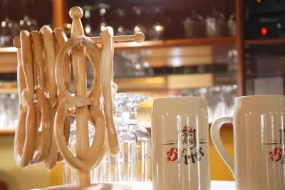 a group of pretzels on a stand next to cups at Guest House Arvaj in Kranj