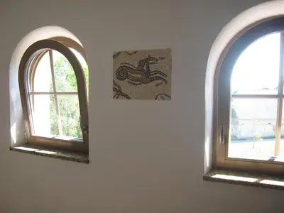 two windows in a room with a picture on the wall at Lipizzaner Lodge Guest House in Postojna