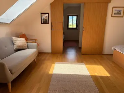 a living room with a couch and a window at Lipizzaner Lodge Guest House in Postojna