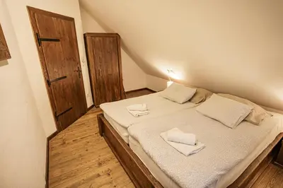 a bedroom with a bed with two towels on it at Panonska Vas Villas in Moravske Toplice