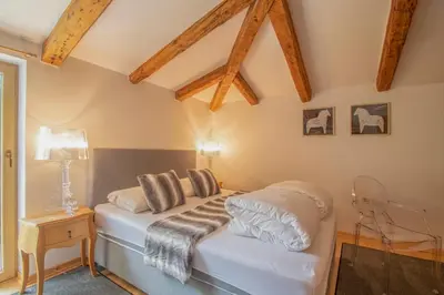 a bedroom with a bed with white sheets and pillows at Residence Apolonija Guest House in Sežana
