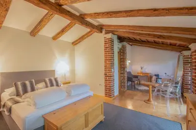 a living room with a white couch and a table at Residence Apolonija Guest House in Sežana