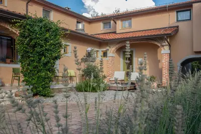 a house with a garden in front of it at Residence Apolonija Guest House in Sežana