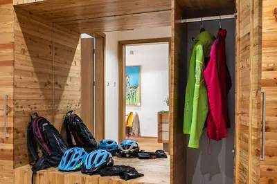 a room with helmets andhelmets on a wooden wall at Vila Vipolže - Rooms & J. Suites in Vipolže