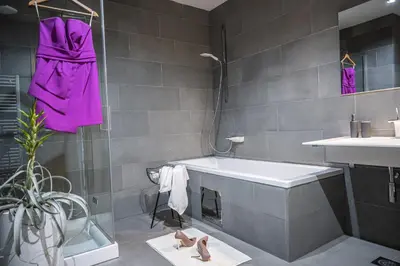 a bathroom with a white tub and a sink at Vila Vipolže - Rooms & J. Suites in Vipolže