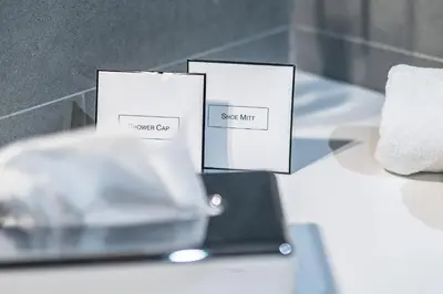 three cards sitting on a table with a wine glass at Vila Vipolže - Rooms & J. Suites in Vipolže