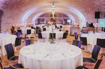 a banquet hall with white tables and chairs at Vila Vipolže - Rooms & J. Suites in Vipolže
