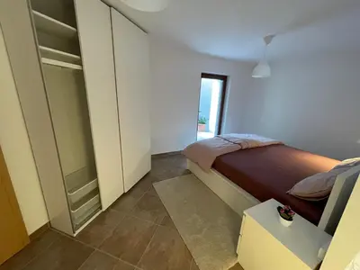a bedroom with a bed and a walk in closet at Apartma 7 - In the heart of Soča Valley in Tolmin