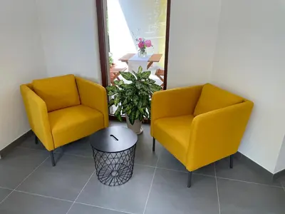 two yellow chairs and a table in a room at Apartma 7 - In the heart of Soča Valley in Tolmin