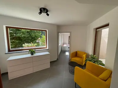 a living room with two yellow chairs and a window at Apartma 7 - In the heart of Soča Valley in Tolmin