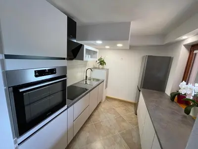 a kitchen with a sink and a stove top oven at Apartma 7 - In the heart of Soča Valley in Tolmin