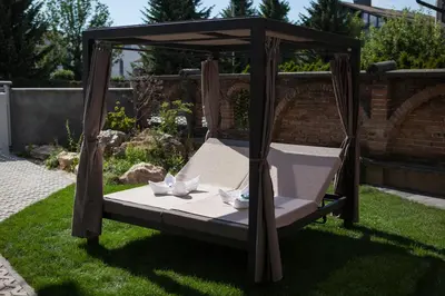 a bed in a gazebo in a yard at Chang Thai apartments in Ljubljana