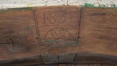 a wooden cutting board with a number on it at Gozdna koča Studeno in Kočevje