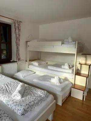 a room with three bunk beds in it at Apartment Hribovc with atrium and free parking in Kranjska Gora