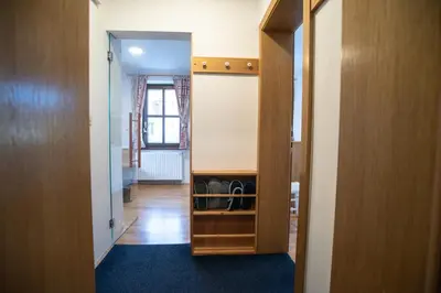 a hallway with a door open to a room at Apartment Hribovc with atrium and free parking in Kranjska Gora