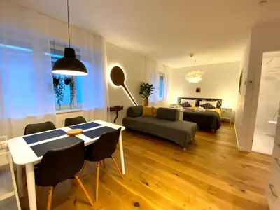 a living room with a table and a couch at Boennium Apartments in Ljubljana
