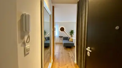 a hallway with a door leading to a living room at Boennium Apartments in Ljubljana