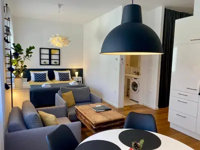 a living room with a couch and a bed at Boennium Apartments in Ljubljana