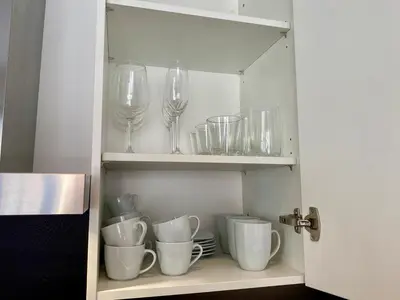 a cupboard with wine glasses and dishes on it at Boennium Apartments in Ljubljana